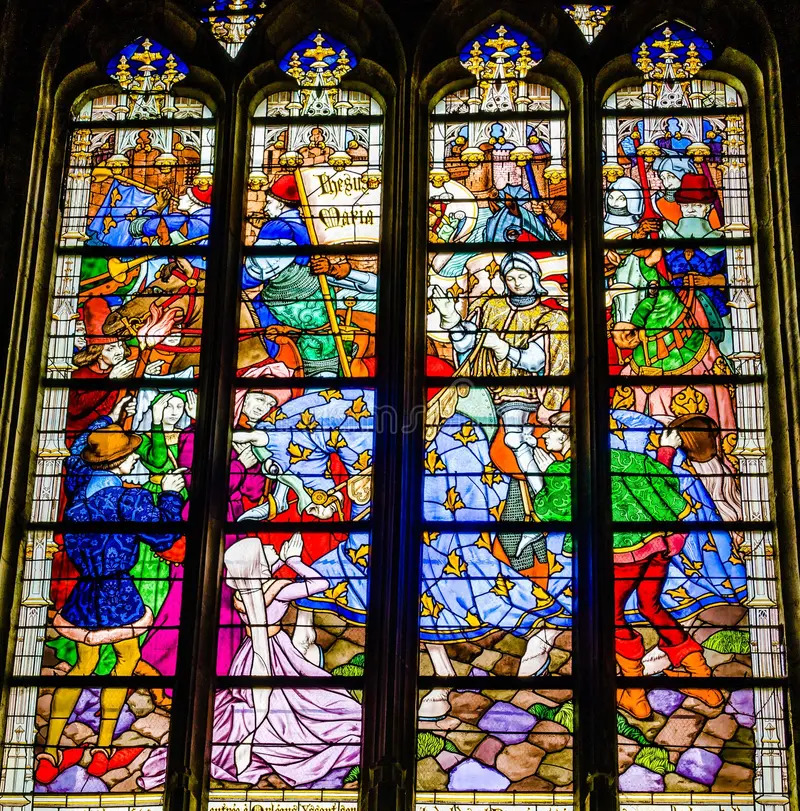 Colorful stained glass cathedral window with medieval figures in four tall panels
