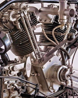 Close-up of a vintage British Anzani radial aircraft engine with exposed metal cylinders and mechanical parts