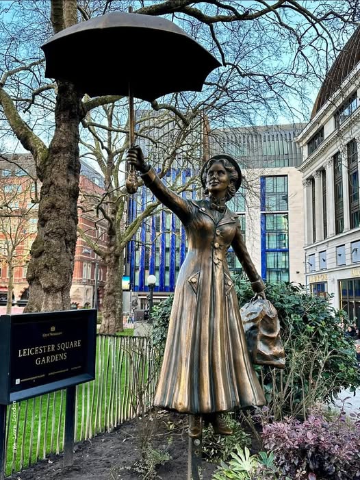 Bronze Mary Poppins statue with umbrella in Leicester Square Gardens, London