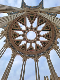 Gothic cathedral vaulted ceiling with ornate stone ribs radiating from central circular dome in star pattern
