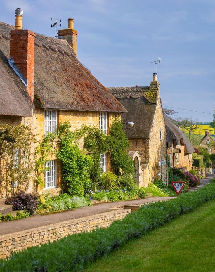 Quaint thatched countryside cottage with colorful flower garden