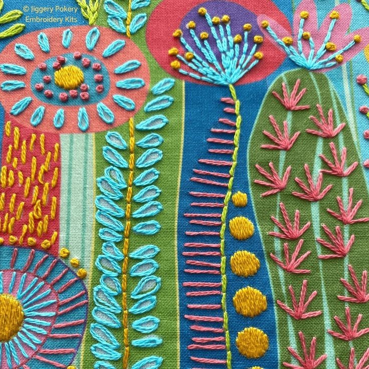 Hand-embroidered textile with colorful cacti, flowers, and geometric patterns on fabric strips