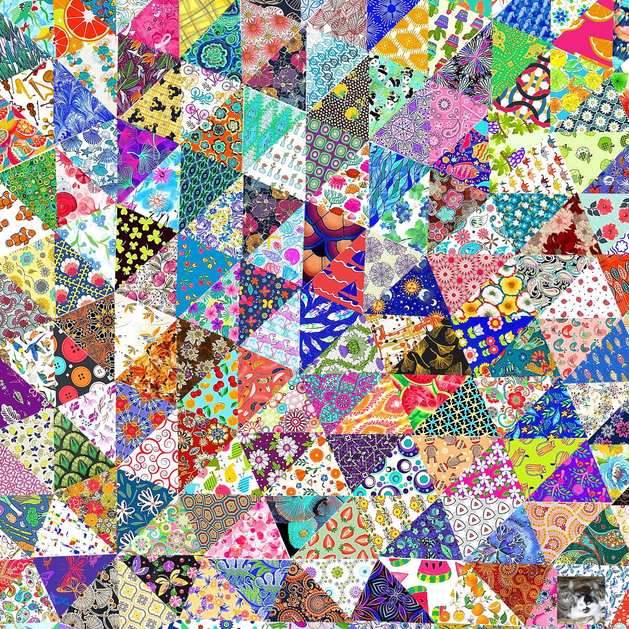 Colorful patchwork quilt with triangular fabric pieces in various patterns including florals, dots, and geometric designs
