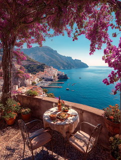 Terrace with a dining table overlooking the Amalfi Coast, framed by pink bougainvillea and blue sea