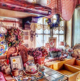Rustic kitchen with red gingham curtains, yellow sink, and floral decorations on windowsill