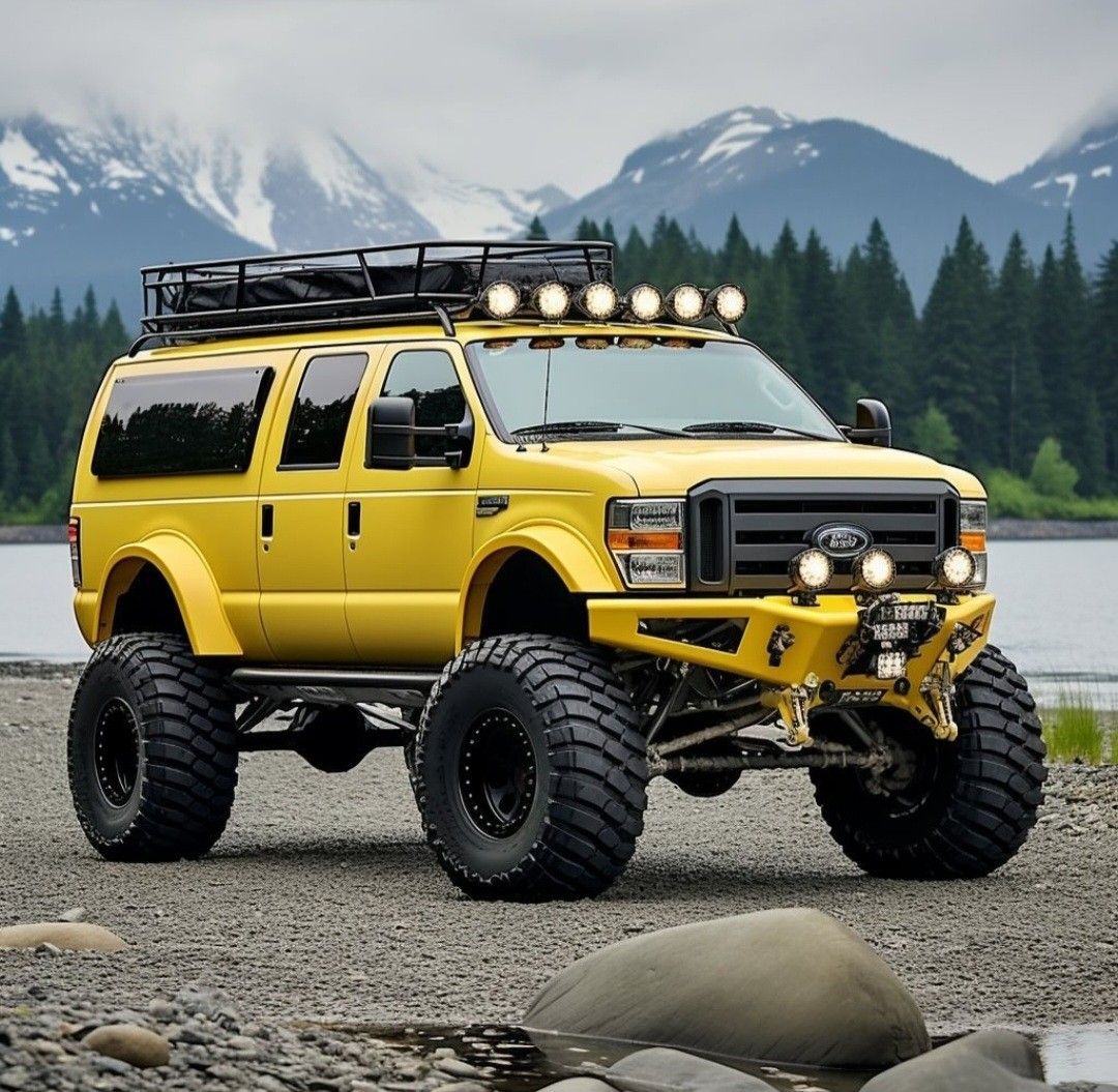 Yellow lifted SUV with large tires and roof lights near mountain lake