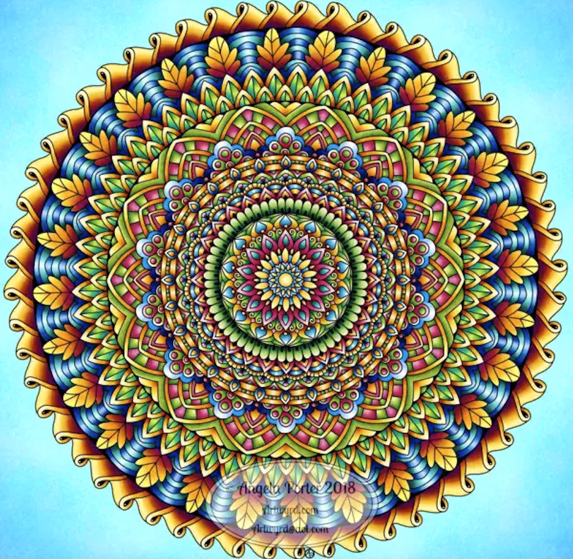 Detailed circular mandala with intricate geometric patterns in blue, orange, green, and yellow hues on light blue background