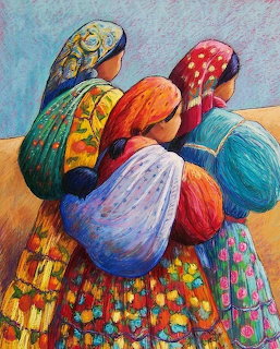 Three women in colorful traditional dress and headscarves seen from behind