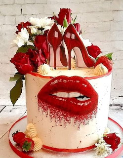 White cake with red lips design, red high heel toppers, roses, and meringues