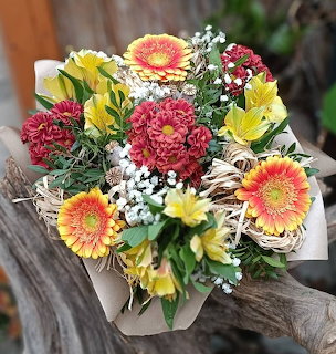 Colorful mixed flower bouquet with gerbera daisies, chrysanthemums, lilies, and baby's breath
