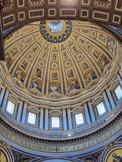 Ornate gold and blue cathedral dome interior with geometric patterns and central skylight