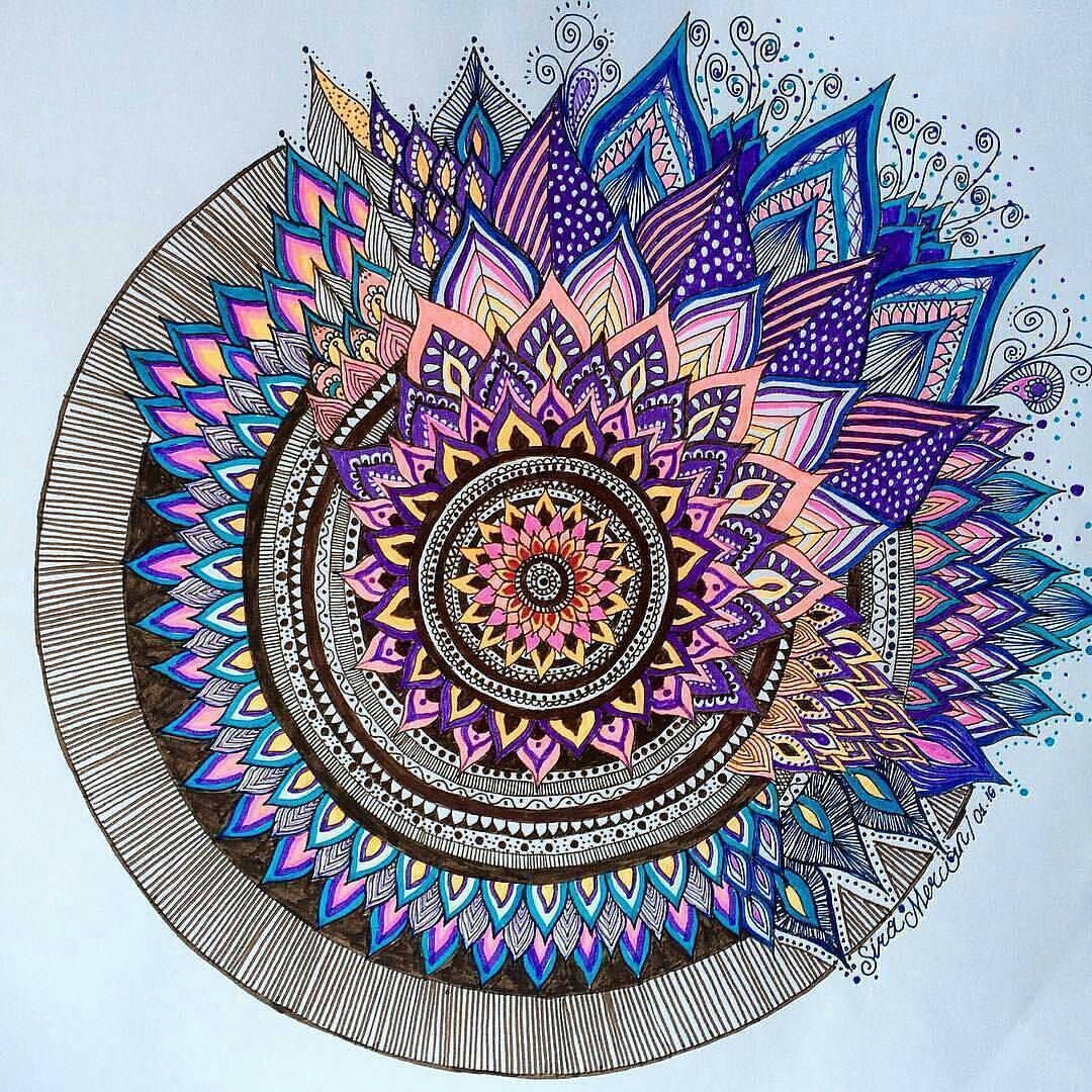 Colorful mandala with spiral geometric pattern in purple, blue, and pink on light blue background