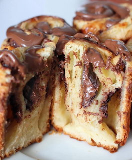 Close-up of sliced cinnamon rolls with chocolate filling and chocolate icing