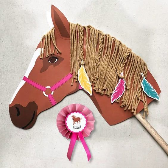 Handmade Arabian horse head craft with yarn mane, feathers, and a pink ribbon