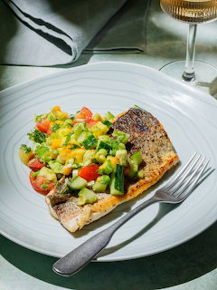 Grilled salmon with corn salsa on white plate