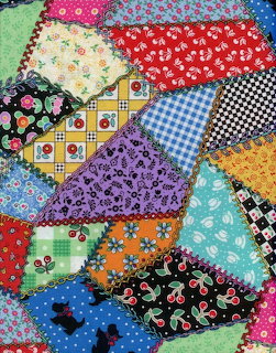 Colorful patchwork quilt with various fabric patterns and textures in bright colors