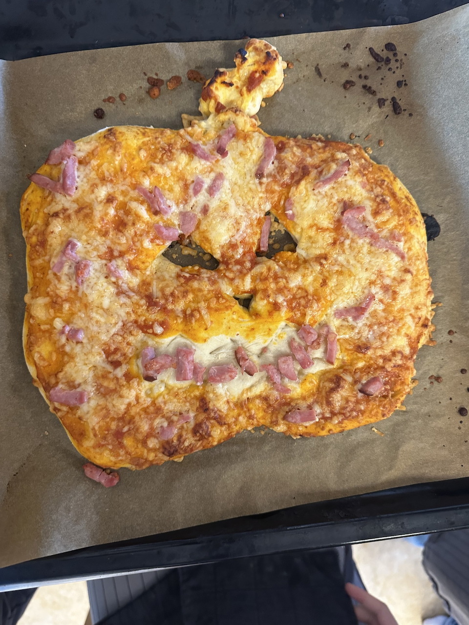 Pizza topped with pumpkin slices, melted cheese and herbs