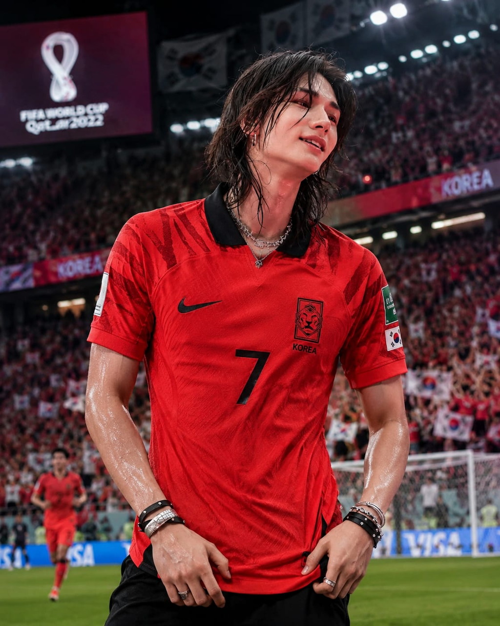 Young man in South Korea red number 7 jersey at FIFA World Cup 2022 stadium