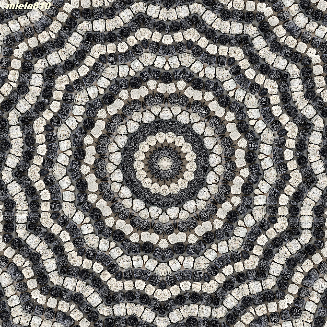 Circular mandala made of gray and beige stone mosaic tiles in radiating concentric pattern