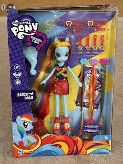Boxed Rainbow Dash fashion doll with colorful hair and accessories in bright packaging