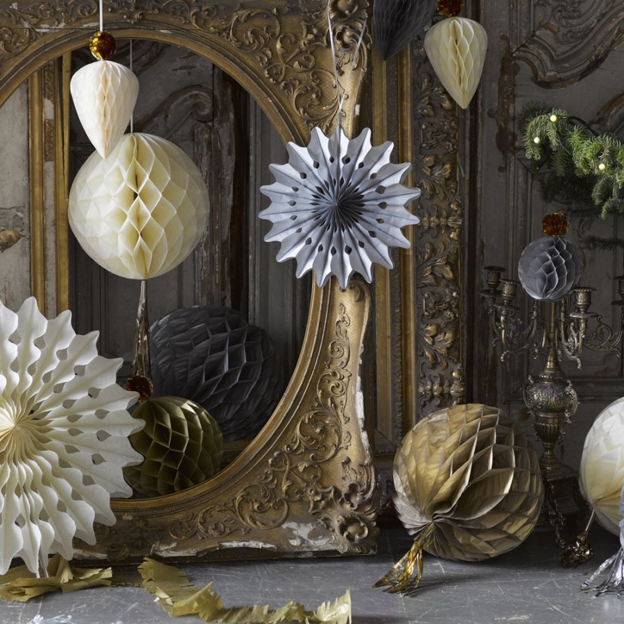 Ornate golden baroque mirror with white paper flowers and hanging decorations