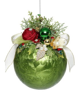 Green Christmas ball ornament adorned with red rose, pearls, jewels, white ribbons, and greenery