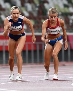 Two women sprinting on a track during a competitive race