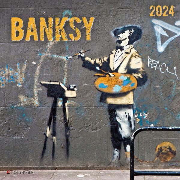 Street art mural of a child painting at an easel on a gray wall with BANKSY text and graffiti