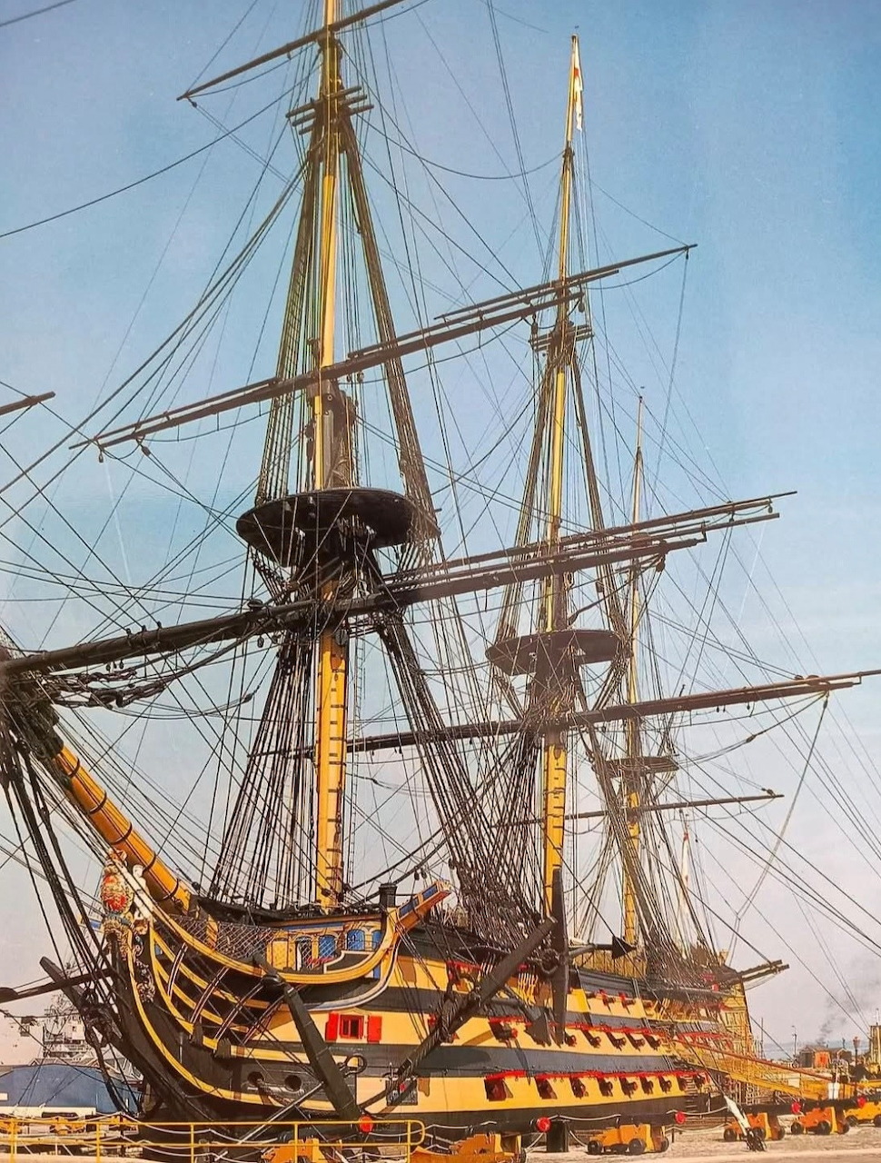 HMS Victory tall ship with masts and rigging docked at harbor