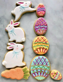 Decorated Easter sugar cookies shaped as bunnies and Easter eggs with colorful royal icing designs