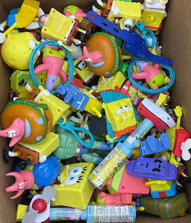 Collection of SpongeBob SquarePants toys and merchandise scattered in a pile