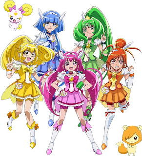 Five Smile PreCure anime magical girls in yellow, blue, pink, green, and orange outfits with mascot characters