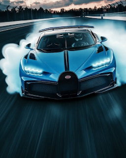 Blue supercar drifting on a racetrack with tire smoke, front view at low angle