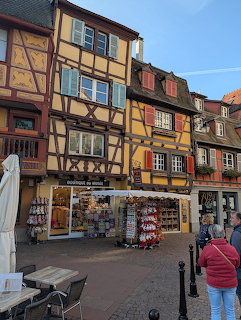 Colorful half-timbered houses with bright shutters along a street in Colmar, France