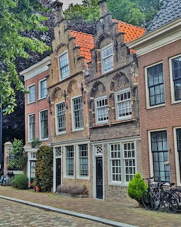 Historic Dutch canal houses with ornate stepped gables and traditional architecture