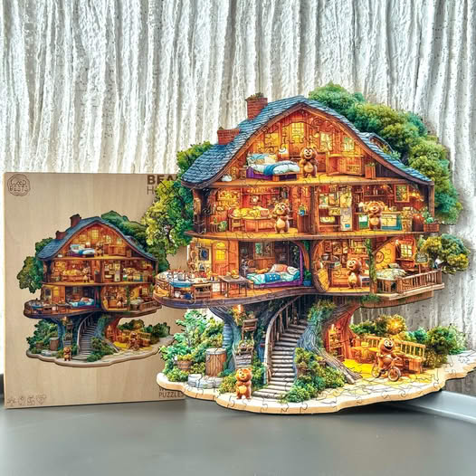 Detailed illustrated treehouse cottage cutout with glowing rooms and stairs displayed indoors