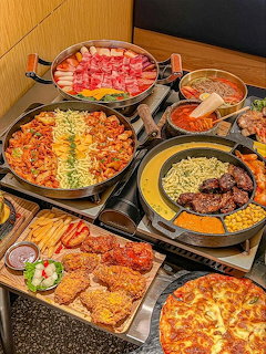 Overhead view of assorted Korean food dishes with rice, kimchi and side plates
