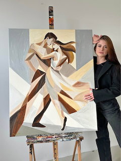 Woman standing next to an abstract painting of a dancing couple on an easel