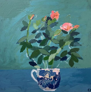 Pink roses in blue patterned teacup painting on teal background