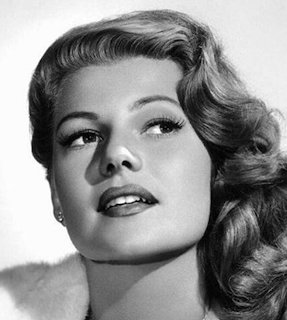 Portrait of Rita Hayworth with wavy auburn hair in classic Hollywood style