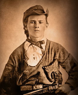 Sepia vintage photograph of a young man in 1800s clothing holding a revolver