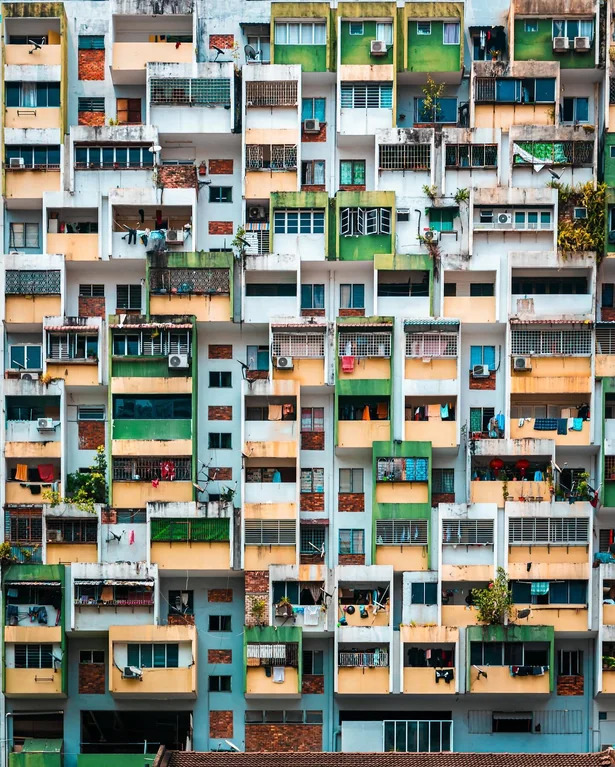 Colorful apartment building facade with many balconies and windows