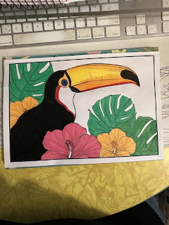 Colorful drawing of a toucan with yellow and orange beak surrounded by tropical leaves and hibiscus flowers