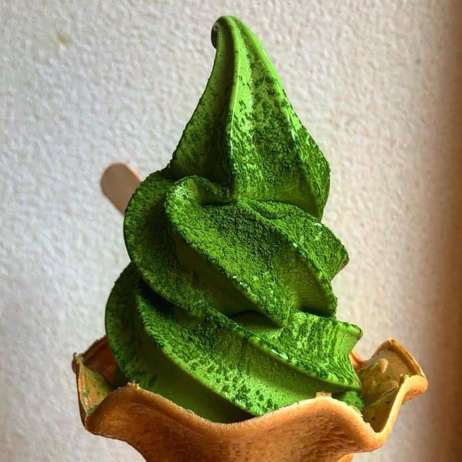 Green matcha soft serve ice cream in a waffle bowl