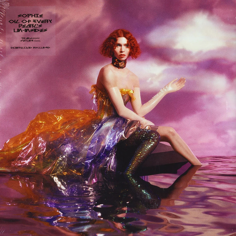 Woman in iridescent flowing gown posing on reflective pink surface with purple cloudy sky background
