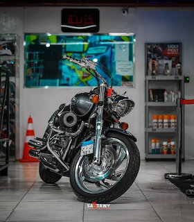 Black Harley Davidson motorcycle parked indoors in a showroom