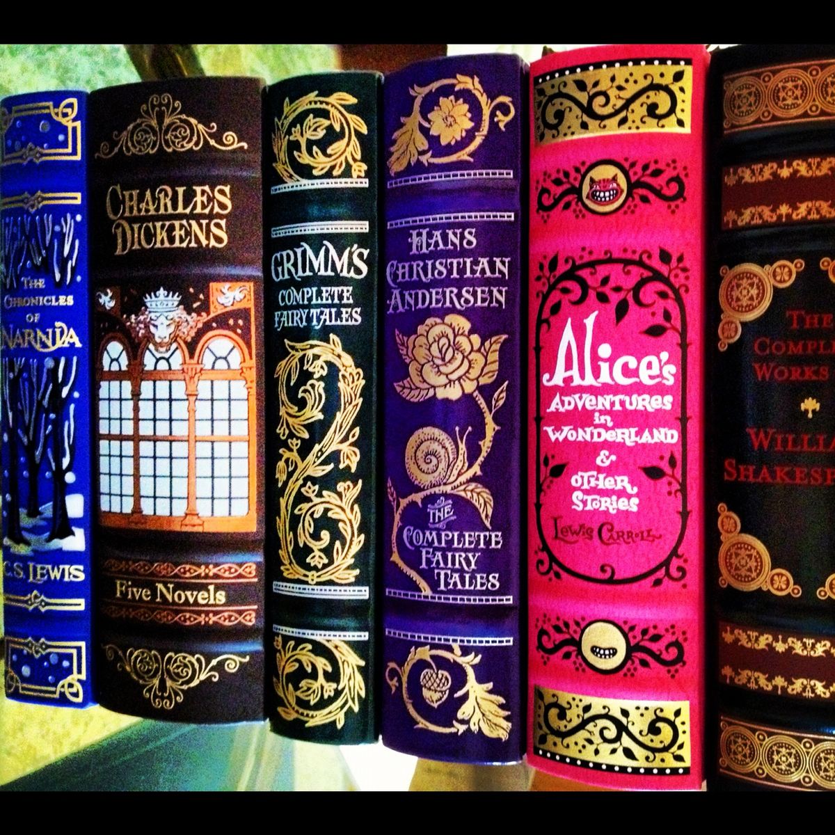 Close-up of colorful ornate vintage book spines with decorative bindings