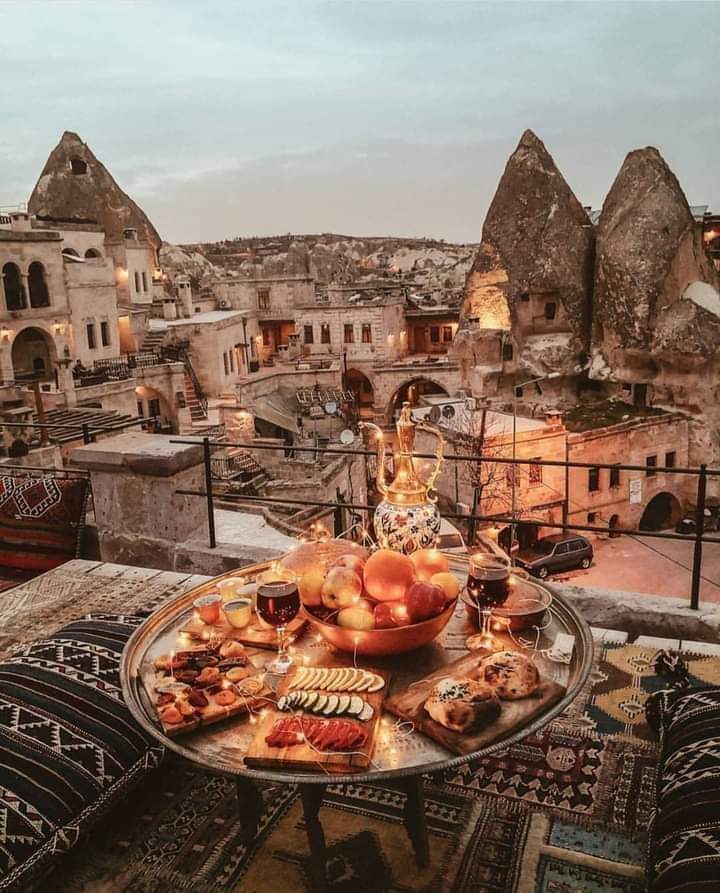 Hot air balloons rising above Cappadocia's rock formations at dawn