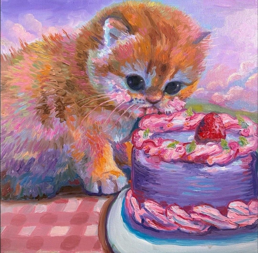 Painted orange kitten next to a purple frosted cake with strawberries