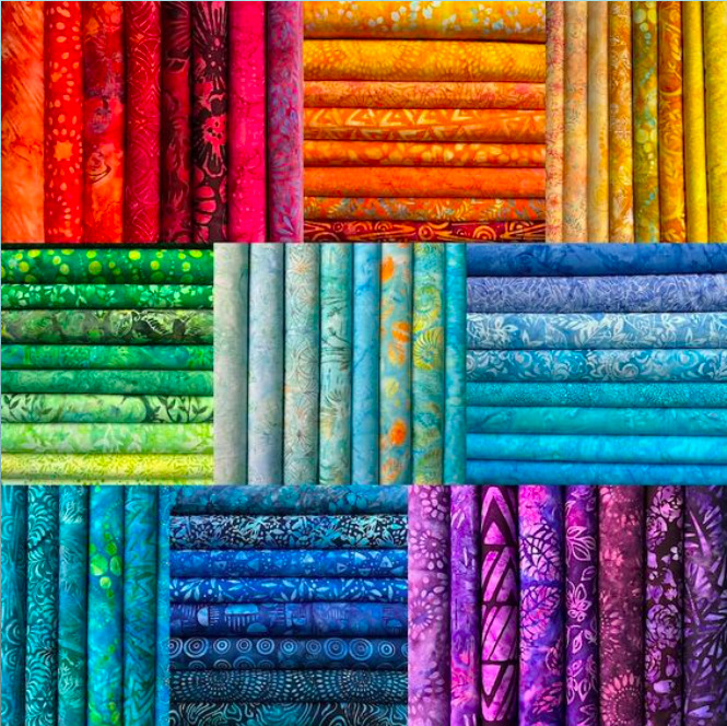 Grid of colorful rolled batik fabric bolts with traditional patterns in various colors including red, green, blue, and purple
